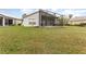 Large backyard with screened patio and grassy area at 212 Rialto Rd, Kissimmee, FL 34759