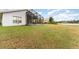 Backyard view of home with pond and landscape at 212 Rialto Rd, Kissimmee, FL 34759