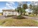 Landscaped yard and exterior of a single story house with a white garage at 212 Rialto Rd, Kissimmee, FL 34759