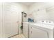 Bright laundry room with washer, dryer, and storage at 212 Rialto Rd, Kissimmee, FL 34759