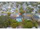 Aerial view of the home showcasing the roof, driveway, pool, landscaping and neighborhood at 2235 Ginger Way, Lakeland, FL 33801