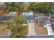 Aerial view of the home showcasing the roof, driveway, pool, landscaping and neighborhood at 2235 Ginger Way, Lakeland, FL 33801