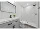 Modern bathroom featuring marble-look tiled shower, light gray vanity and matte black fixtures at 2235 Ginger Way, Lakeland, FL 33801