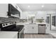 Modern kitchen featuring white cabinets, stainless steel appliances, and stylish backsplash at 2235 Ginger Way, Lakeland, FL 33801