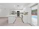 Modern kitchen featuring white cabinets, quartz countertops, stainless steel appliances, and views of the pool at 2235 Ginger Way, Lakeland, FL 33801