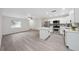 Bright and open living space with a view of the modern kitchen and stainless steel appliances at 2235 Ginger Way, Lakeland, FL 33801