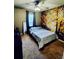 Bright bedroom featuring a full bed and tree mural at 2545 Old Kent Cir, Kissimmee, FL 34758