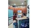 Kitchen with light wood cabinets and a teal refrigerator at 2545 Old Kent Cir, Kissimmee, FL 34758