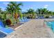 Relaxing pool deck with blue lounge chairs at 2545 Old Kent Cir, Kissimmee, FL 34758