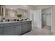 Double vanity bathroom with granite countertop and gray cabinets; access to a walk-in closet at 2912 Moulin Rd, Davenport, FL 33837