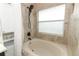 Clean bathroom with a shower/tub combo and a window for natural light at 30129 Pga Dr, Sorrento, FL 32776