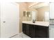 Elegant bathroom with dark wood cabinets and a modern vanity at 30129 Pga Dr, Sorrento, FL 32776