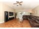 Living room with sectional sofa, TV, and sliding doors to the patio at 30129 Pga Dr, Sorrento, FL 32776