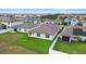 Aerial view of houses with solar panels and fenced backyards at 309 Citrus Isle Loop, Davenport, FL 33837