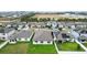 Aerial view of houses showcasing backyard patios and solar panels at 309 Citrus Isle Loop, Davenport, FL 33837