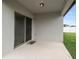 Covered patio with sliding glass doors leading to the backyard at 309 Citrus Isle Loop, Davenport, FL 33837