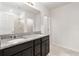 Bathroom boasts double vanity with granite countertop at 309 Citrus Isle Loop, Davenport, FL 33837