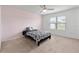 Cozy bedroom featuring a bed, window, and light pink wall at 309 Citrus Isle Loop, Davenport, FL 33837