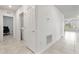 Clean hallway with tile floors and laundry access at 309 Citrus Isle Loop, Davenport, FL 33837