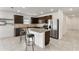 Modern kitchen with dark cabinets and granite countertops at 309 Citrus Isle Loop, Davenport, FL 33837