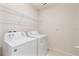 Laundry room with washer, dryer, and shelving at 309 Citrus Isle Loop, Davenport, FL 33837