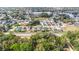 Aerial view showing the house's location in a residential neighborhood near a lake at 3131 Ash Park Loop, Winter Park, FL 32792