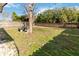 Fenced backyard with brick wall, picnic table, and mature tree at 3131 Ash Park Loop, Winter Park, FL 32792