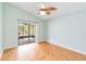 Light and airy bedroom with wood floors and patio access at 3131 Ash Park Loop, Winter Park, FL 32792