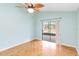 Bright bedroom with wood flooring, ceiling fan, and sliding glass door to patio at 3131 Ash Park Loop, Winter Park, FL 32792