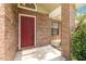 Brick home with a red front door and covered porch at 3131 Ash Park Loop, Winter Park, FL 32792