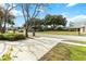 Landscaped front yard with mature trees and curb appeal at 3131 Ash Park Loop, Winter Park, FL 32792