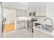 Modern kitchen with stainless steel appliances and white cabinets at 3131 Ash Park Loop, Winter Park, FL 32792