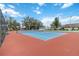 Community tennis court with red and blue surface at 3131 Ash Park Loop, Winter Park, FL 32792