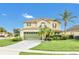 Two-story house featuring a green garage door and lush lawn at 3235 Abiaka Dr, Kissimmee, FL 34743