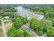 Aerial view of a house near a lake with lush green trees at 3645 Mirror Lake Dr, Apopka, FL 32703