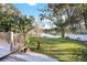 Backyard with deck, lake view, lush lawn, and dock at 3645 Mirror Lake Dr, Apopka, FL 32703