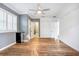 Bright bedroom featuring wood-look floors and an ensuite bathroom at 3645 Mirror Lake Dr, Apopka, FL 32703