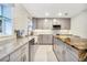 Modern kitchen with gray cabinets, granite countertops, and a farmhouse sink at 3645 Mirror Lake Dr, Apopka, FL 32703