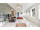 Sunroom with grey tile accent wall, recliner, and large windows at 3645 Mirror Lake Dr, Apopka, FL 32703