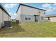 Backyard featuring grass and the rear elevation of the house with a sliding glass door at 3801 Giorgio Dr, Winter Haven, FL 33884