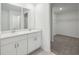 Elegant bathroom featuring double sinks, a spacious vanity, and access to a walk-in closet at 3801 Giorgio Dr, Winter Haven, FL 33884