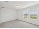 Bright bedroom has neutral carpet, a large window, and a ceiling light at 3801 Giorgio Dr, Winter Haven, FL 33884