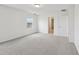 Bright bedroom featuring soft carpeting and a window overlooking the neighborhood at 3801 Giorgio Dr, Winter Haven, FL 33884