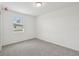 A well lit bedroom with neutral carpeting, a window with blinds and white walls at 3801 Giorgio Dr, Winter Haven, FL 33884