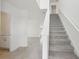 Bright entryway featuring tile floors, white walls, and a carpeted staircase leading upstairs at 3801 Giorgio Dr, Winter Haven, FL 33884