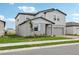 View of a two-story home with gray siding, well-maintained lawn, and neat landscaping at 3801 Giorgio Dr, Winter Haven, FL 33884