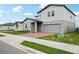 Two story home with a gray garage door, tidy lawn, and red brick driveway at 3801 Giorgio Dr, Winter Haven, FL 33884