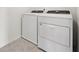 Bright laundry area featuring a new white washer and dryer, and tile floors at 3801 Giorgio Dr, Winter Haven, FL 33884