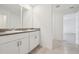 Bright bathroom featuring double sinks, white cabinets, and tile flooring at 3833 Giorgio Dr, Winter Haven, FL 33884