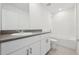 Bright bathroom featuring white cabinets, tile floors and a shower and tub combination at 3833 Giorgio Dr, Winter Haven, FL 33884